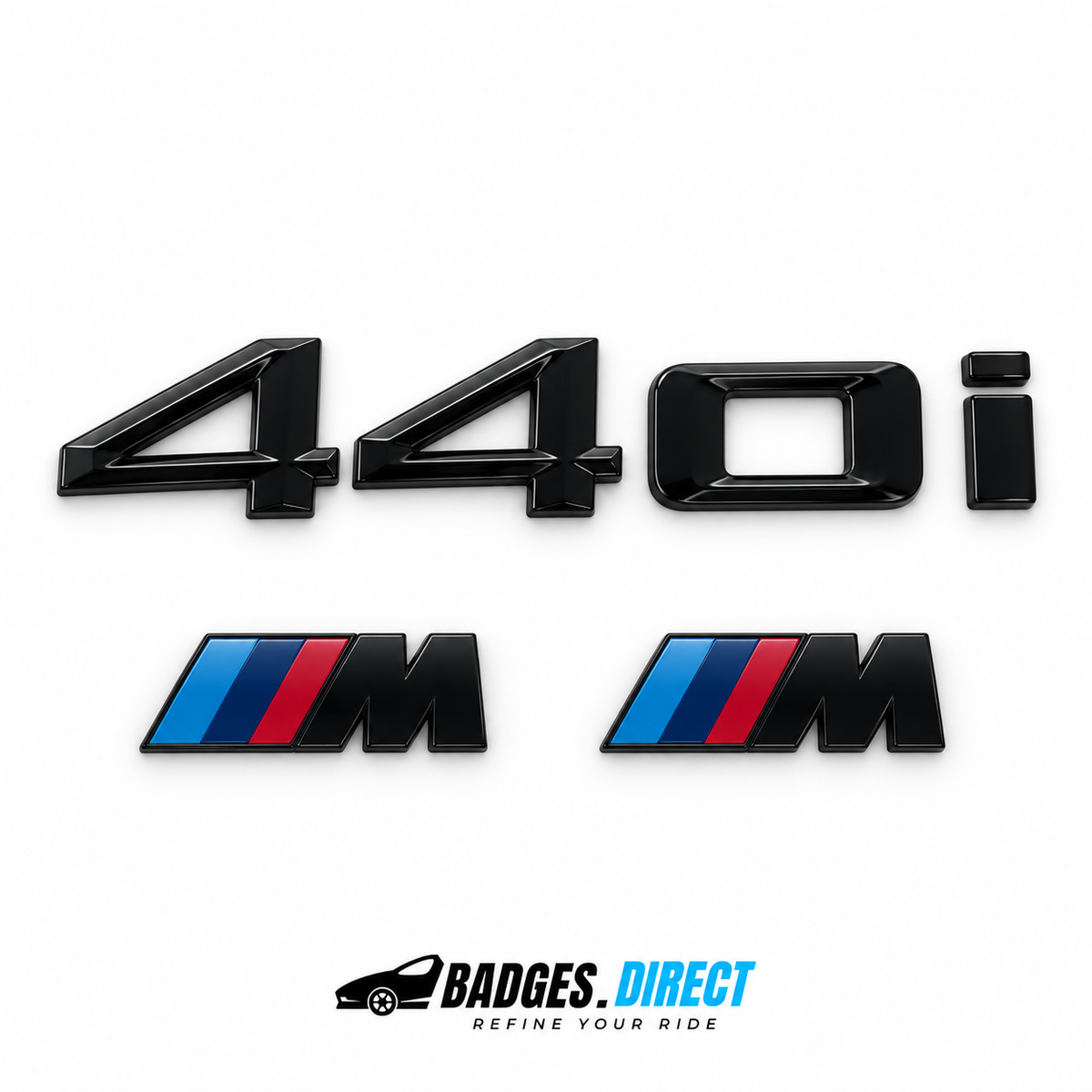 Gloss black BMW 440i rear lettering and two M wing badges with blue and red stripes.