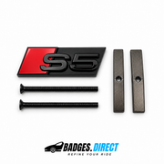 Black and red Audi S5 grille badge with two mounting screws and two mounting bars